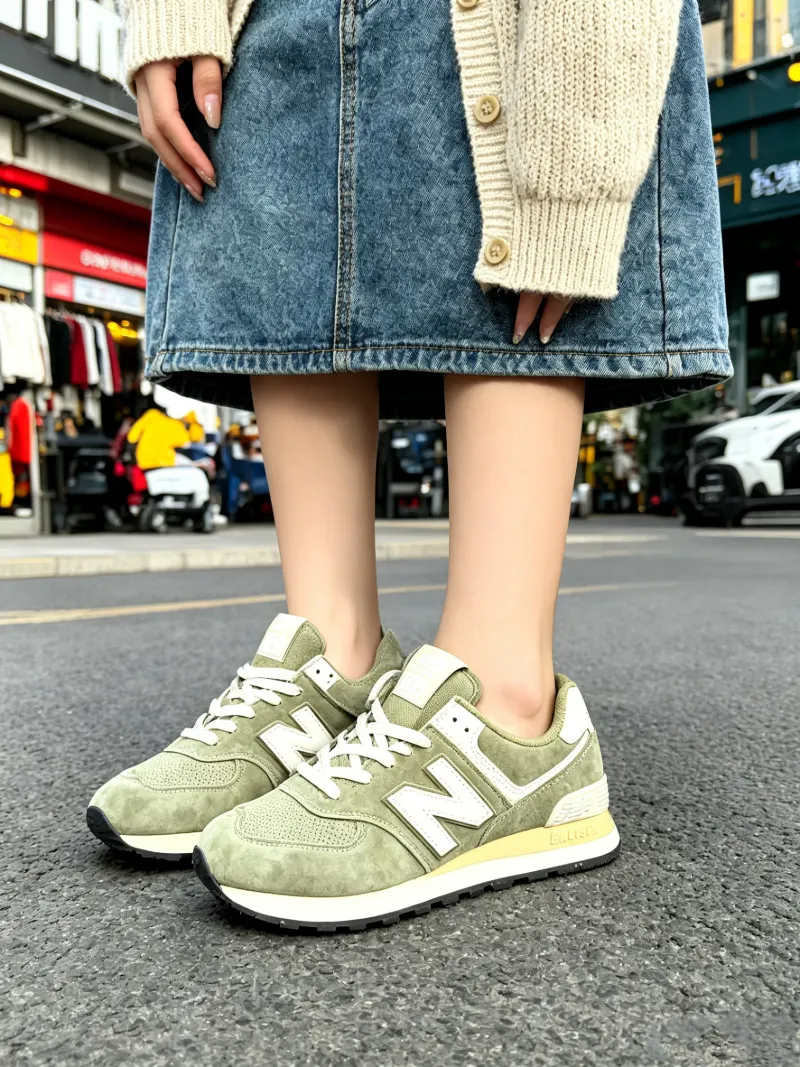 Feminine street style pairing the 574 with a denim skirt and knit layers